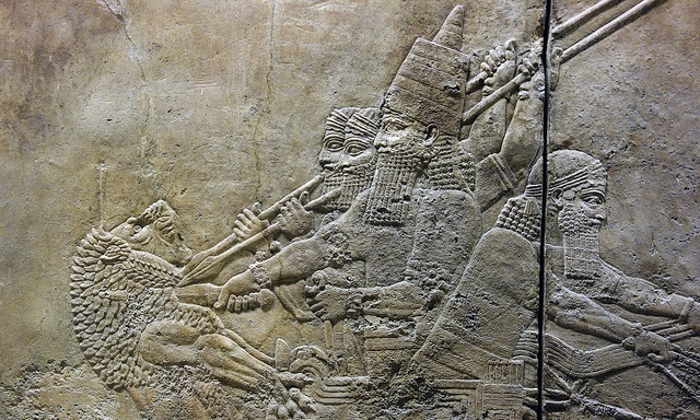 Ashurbanipal slitting the throat of a lion from his chariot